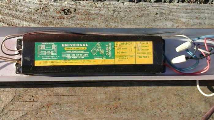 Universal Therm-O-Matic X 34/40w Rapid Start Ballast (late 1970s-early 1980s)
Imagine my surprise when I opened up an inexpensive 1980s 4ft shoplight expecting to find yet another residential-grade low-power-factor (junk) ballast and instead revealed this! It's in more or less perfect shape, with no signs of running hot, (Also evidenced by the fact it came with 40w lamps too; 1994 Sylvania F40/CW).  It practically instant-starts lamps every time and runs them nice and bright, unlike many other later residential-grade ballasts. 

Like many other lamps, ballasts, fixtures, etc. I've collected, this one is somewhat special to me because I have a connection to where this fixture came from.  Back in 2008-2011, my dad did a bunch of work on a house for someone, and I think he may have even put up this fixture in the shed/garage; I remember when it went there, it replaced something I think may have even had Westy blackender lamps.  (But those lamps/fixture are now LONG gone and I'm relying strictly on childhood memories here).  

It's fairly quiet, lacking the raspy-sounding buzz many Universal ballasts like this seem to get after running daily for 30+ years.  This one has probably had substantially less use than a couple other older Universals I have (Old enough they still have PCBs!).  In fact, this ballast spent about three years never being powered up at all (wiring to outbuilding disconnected) up until last week LOL. 

The outbuilding it was in is being torn down.  I walk by that place every day to and from school so I was inquiring about the stripped-out building and was asked if I wanted the fixture.  I said yes of course, and that afternoon went and saved it.  After seeing the ballast inside, I'm very glad I chose to do so! 

Full-power (.80a line current) and non-PCB, the BEST kind!
Keywords: Lamps